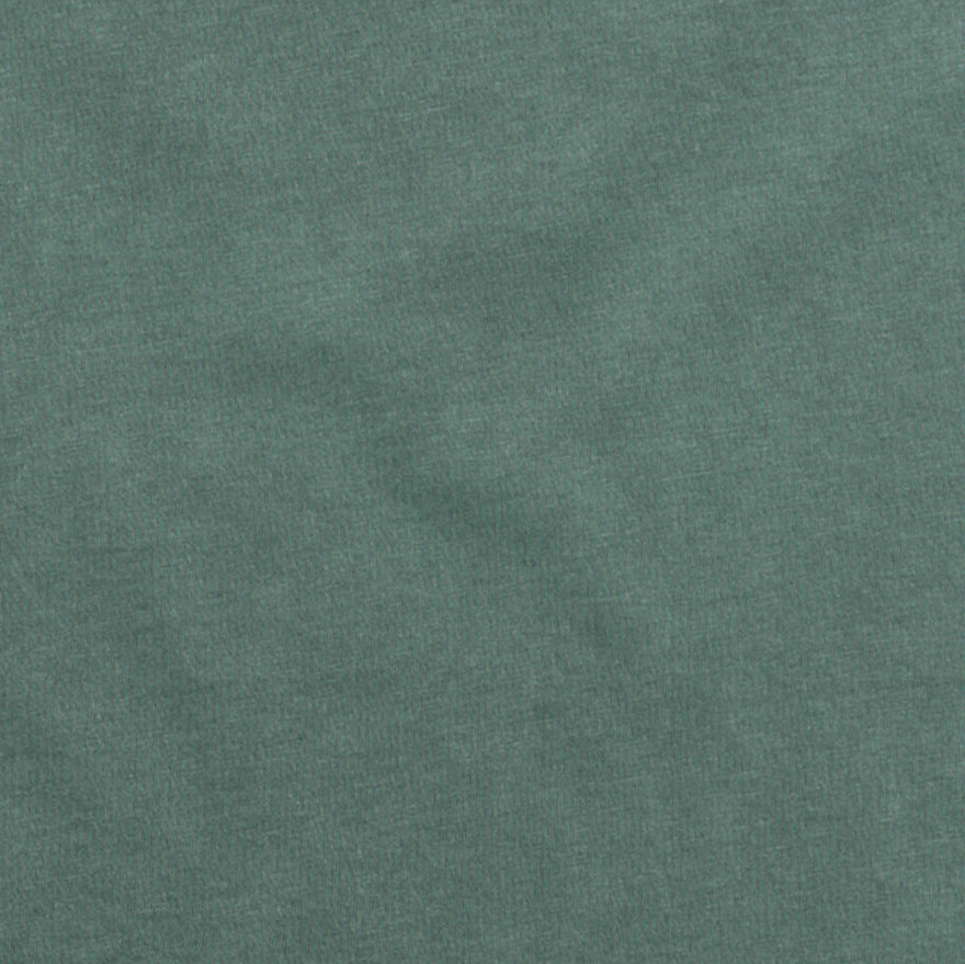 Textured green apparel fabric swatch, soft heather material closeup