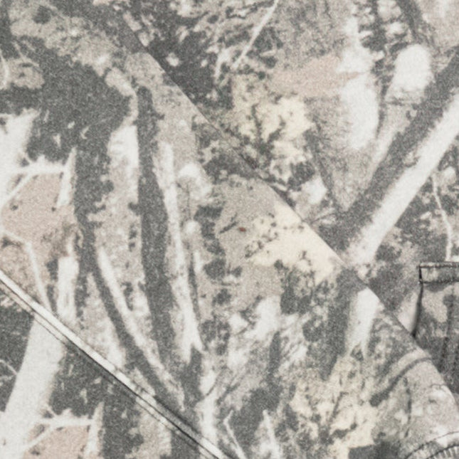 Close-up of grey and beige camouflage hoodie fabric with natural forest pattern.