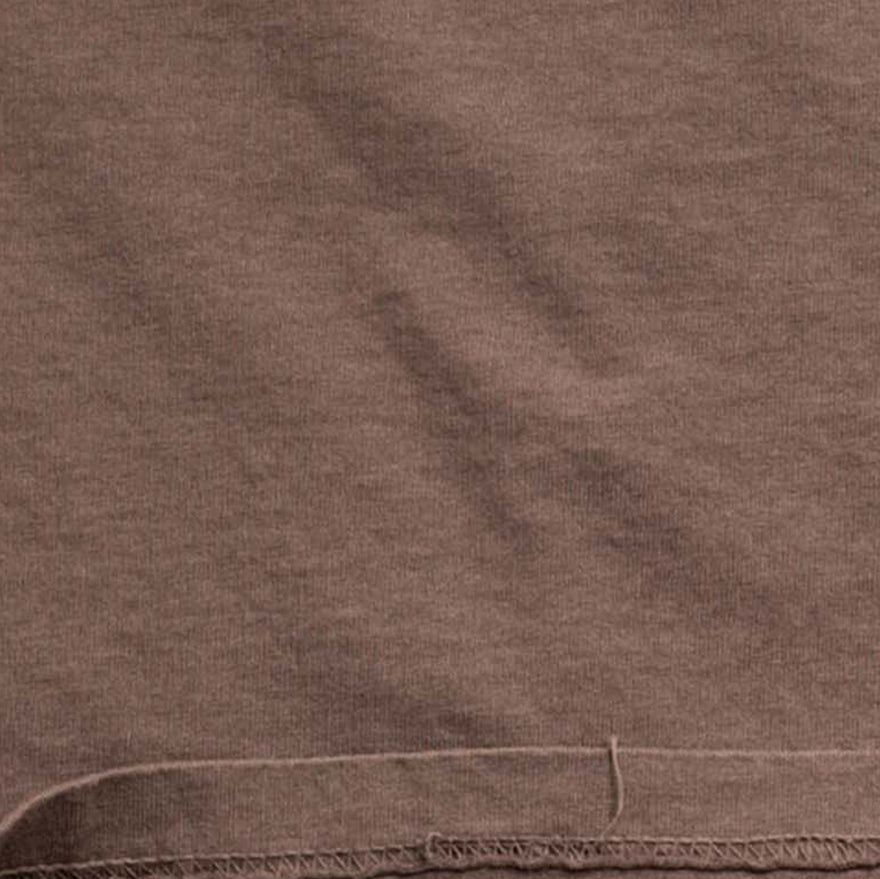 Brown cotton fabric swatch with visible stitching, apparel material close-up