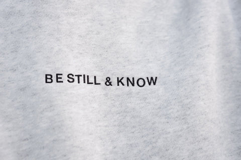 Heather White (BE STILL & KNOW) | BE STILL AND KNOW embroidered in black, Brett is 6'1" wearing size M