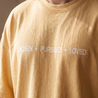 Detail of the chest print as worn, showing the print sitting flush with the cotton knit