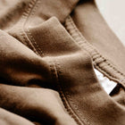 Close-up of premium brown cotton oversized tee collar and stitching details