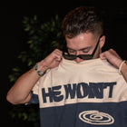 Man wearing streetwear t-shirt with 'HE WON'T' and swirl graphic, mental health fashion